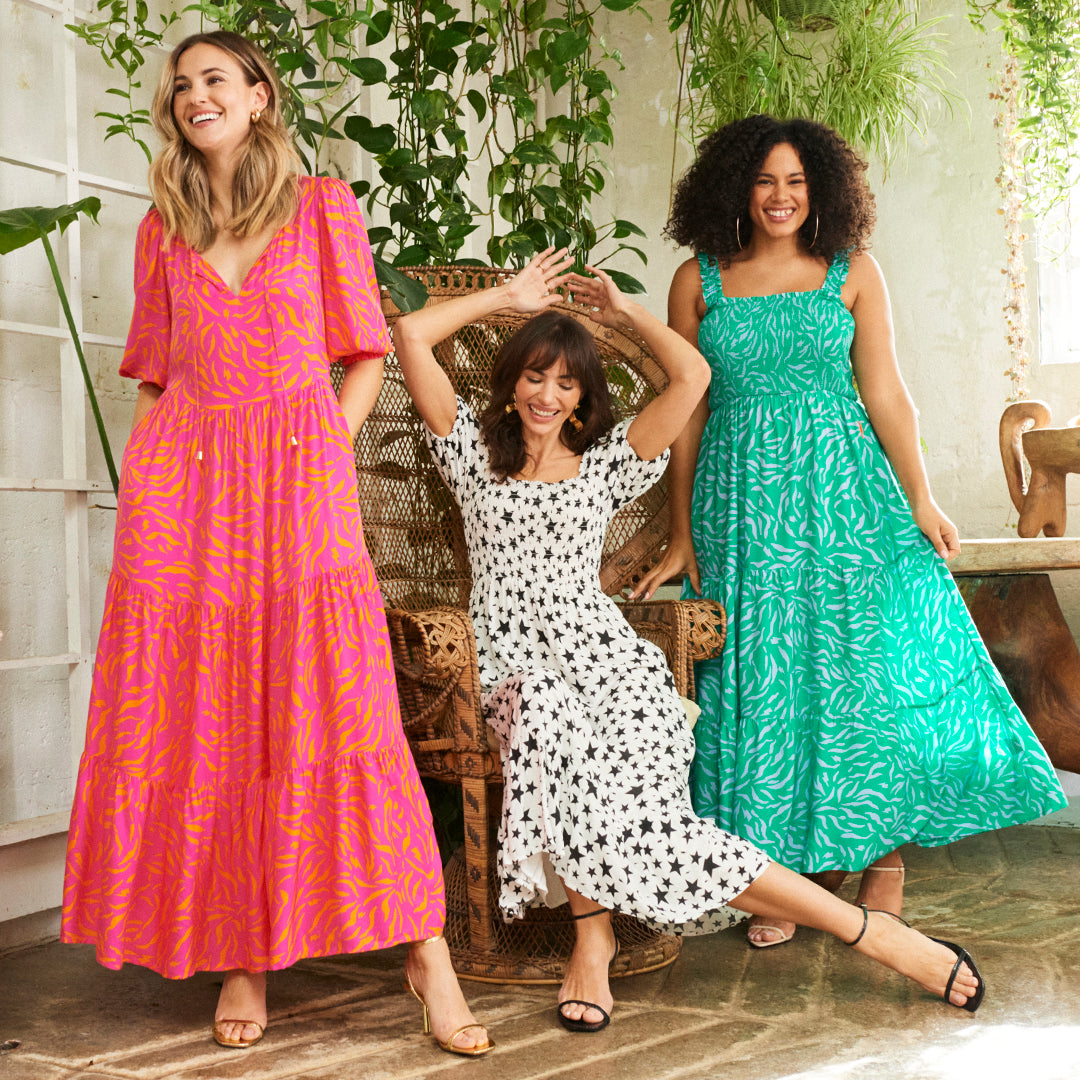 Three women wearing Scamp & Dude dresses from the Brighter Days collection