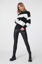 Scamp and Dude Black with White Stripe Oversized Turtle Neck Jumper | Model wearing black and white striped jumper with black black jeans and black boots