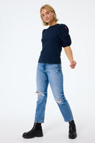 Scamp and Dude Navy Pintuck Sleeve T-Shirt | Model wearing indigo jeans with a navy pintuck sleeve t shirt and black boots.