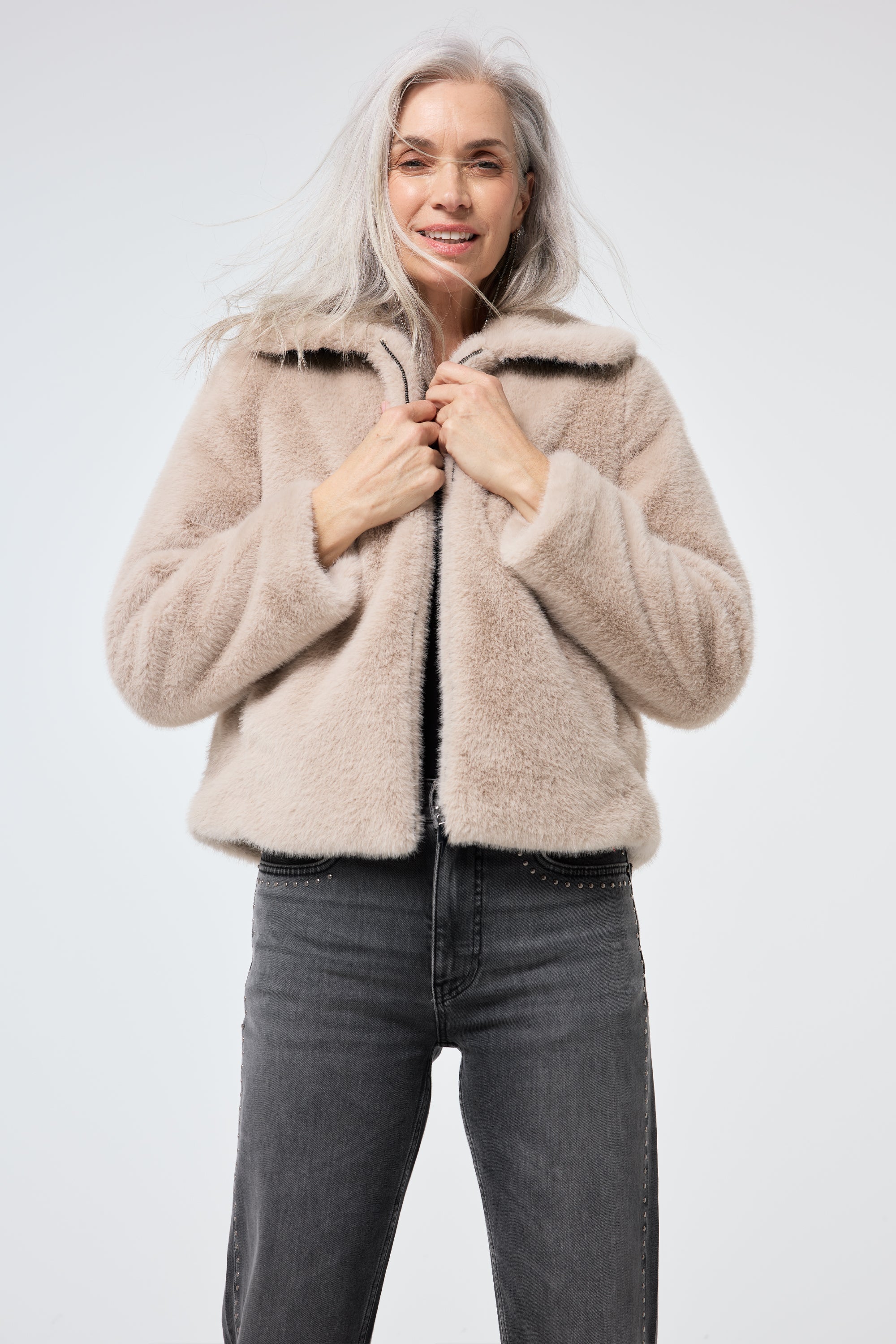 Scamp and Dude Cream Faux Fur Jacket | Model wearing washed black jeans with a faux fur jacket.