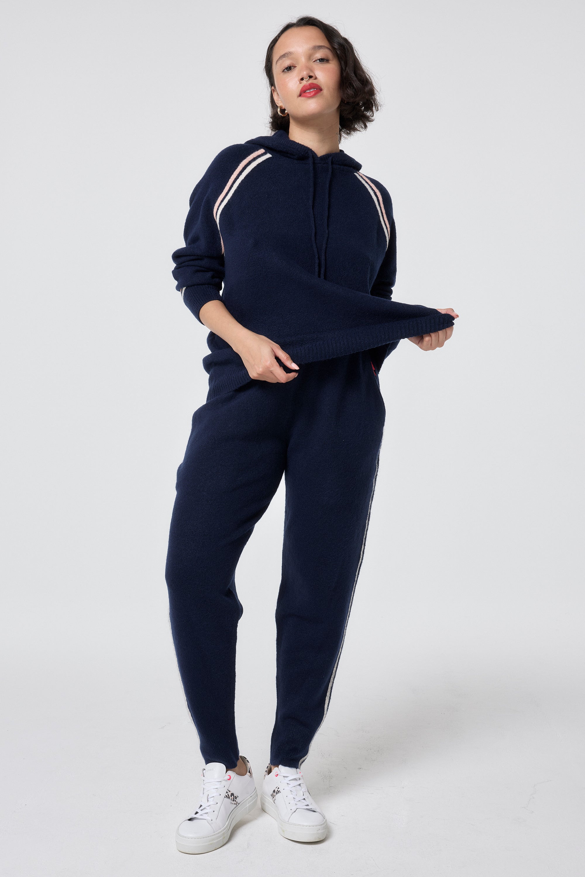 Scamp and Dude Navy with Ivory and Peach Stripe Knitted Lounge Wear Joggers | Model wearing a navy knitted joggers featuring stripe detail paired with the matching hoodie.