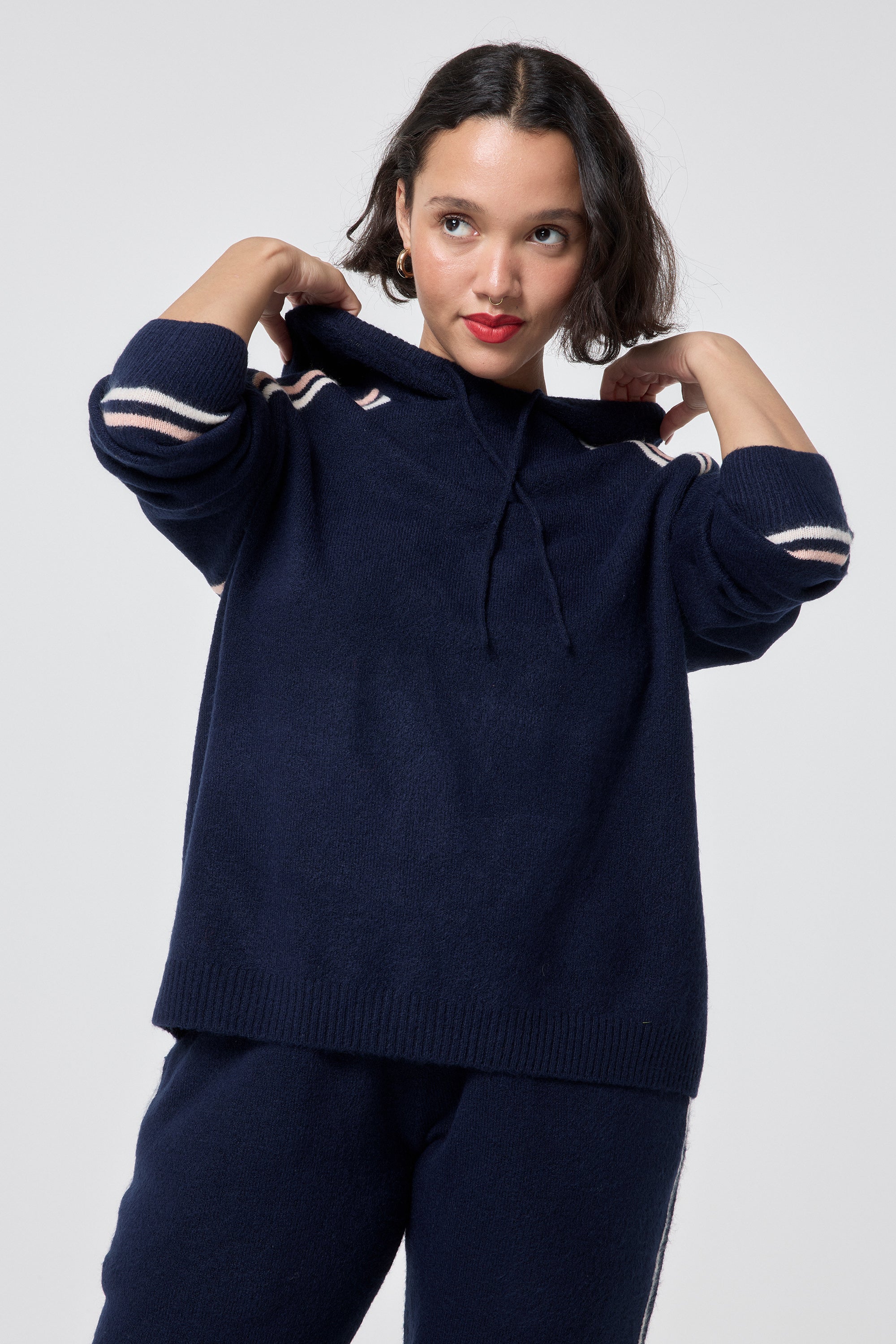 Scamp and Dude Navy with Ivory and Peach Stripe Knitted Lounge Wear Hoodie | Model wearing a navy knitted hoodie featuring stripe detail with matching joggers.