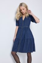 Scamp and Dude Authentic Indigo Zip Detail Tiered Short Denim Dress | Model wearing a blue short denim zip front dress with polka dot tights and boots.