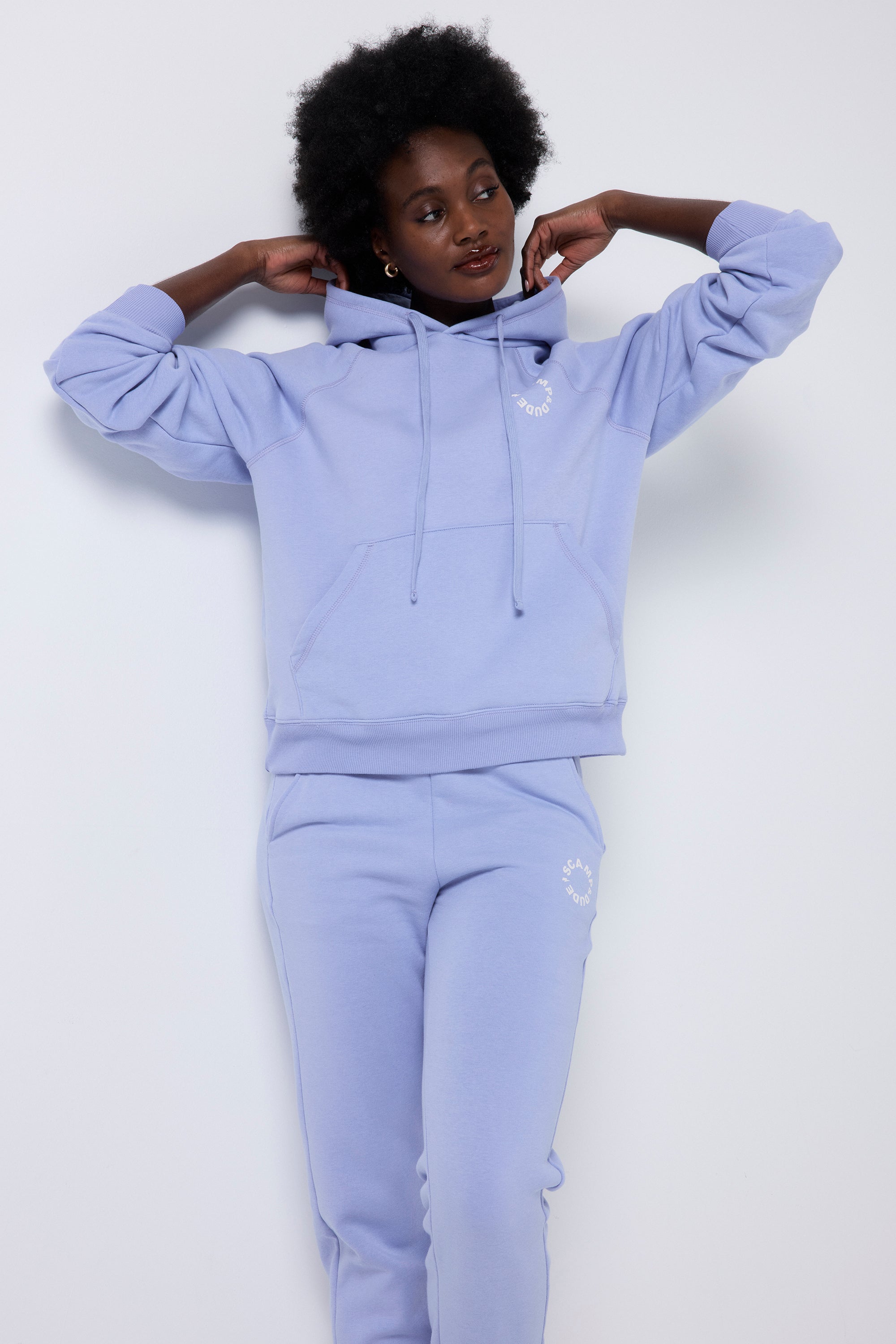 Scamp and Dude Blue Scamp & Dude Logo Relaxed Hoodie | Model wearing a blue hoodie with Scamp & Dude graphic logo on the front and back. Paired with matching joggers.