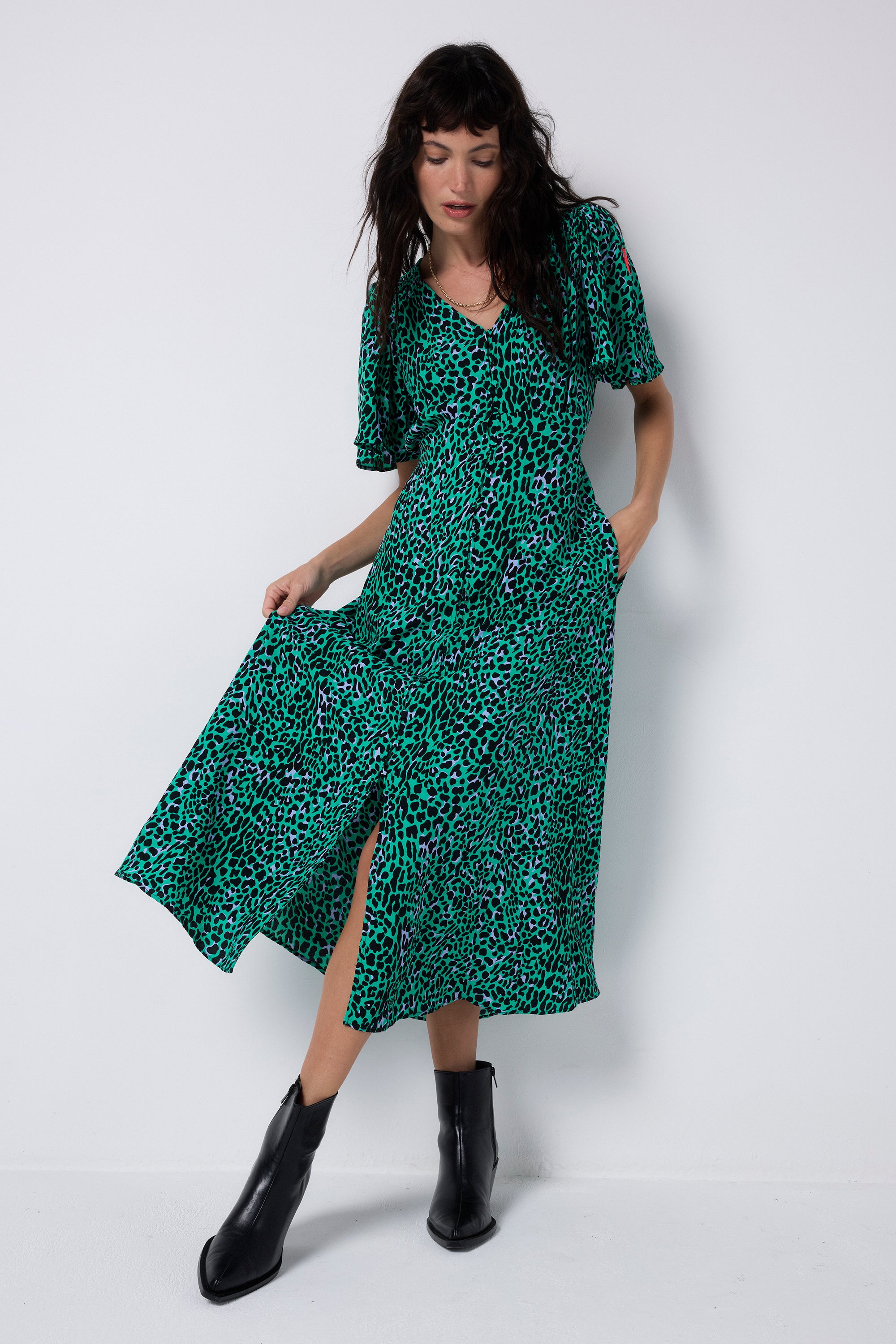 Scamp and Dude Green with Black Leopard Angel Sleeve Midi Tea Dress | Model wearing a green midi tea dress featuring a black leopard print and angel sleeves.