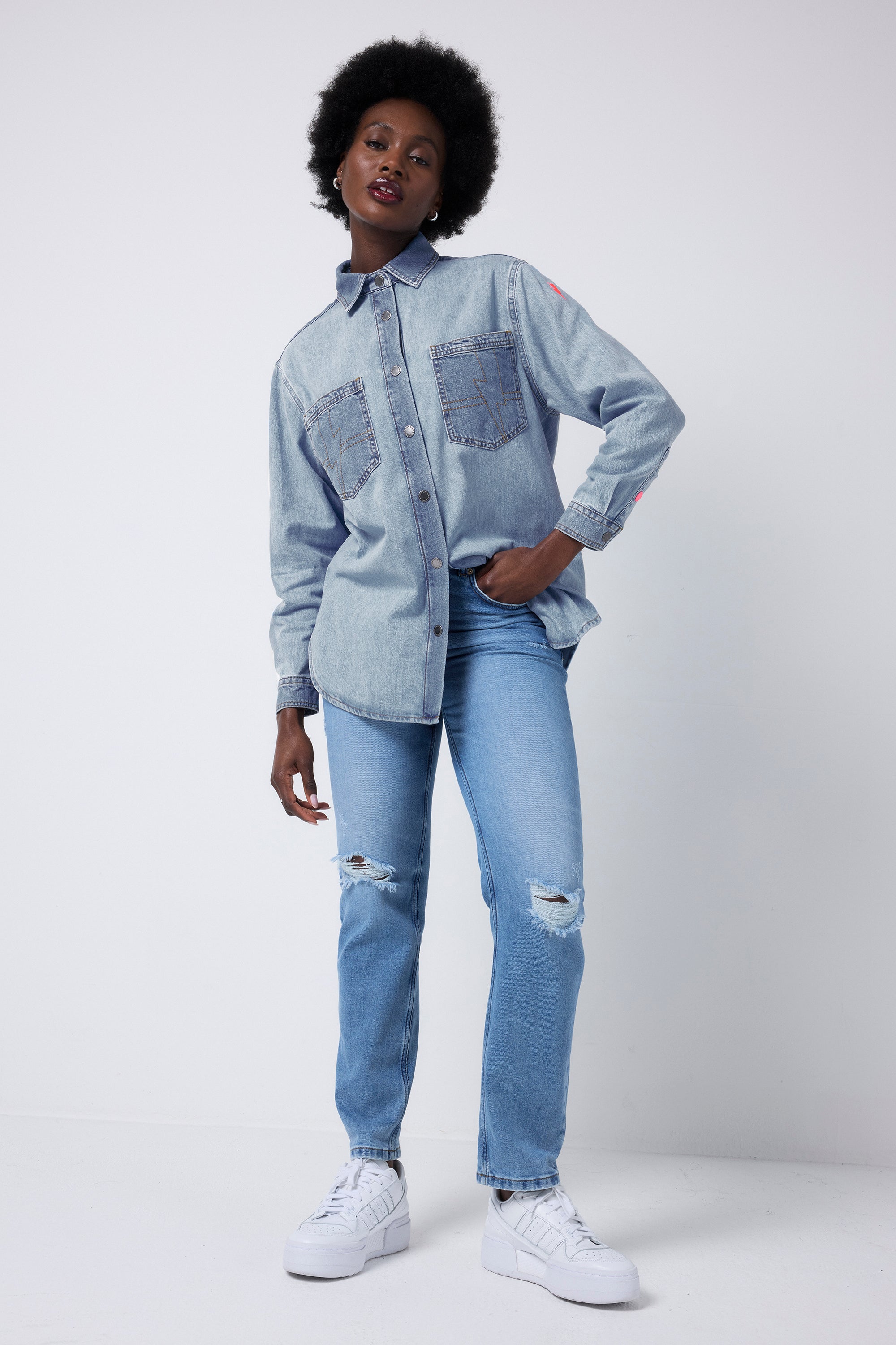 Scamp and Dude Pale Indigo Relaxed Denim Shirt | Model wearing blue distressed denim jeans with a mixed wash pale blue denim shirt.