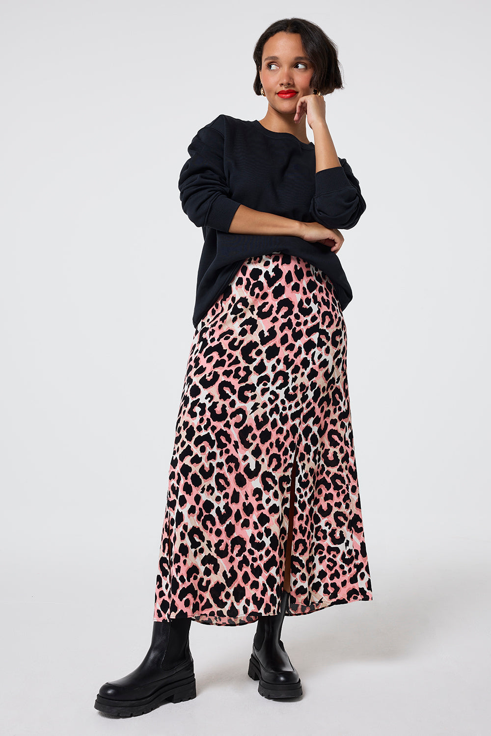 Scamp and Dude Mixed Neutral with Black Shadow Leopard Split Front Skirt | Model wearing a black sweatshirt with a mixed neutral leopard print midi skirt and black chunky boots.