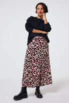 Scamp and Dude Mixed Neutral with Black Shadow Leopard Split Front Skirt | Model wearing a black sweatshirt with a mixed neutral leopard print midi skirt and black chunky boots.