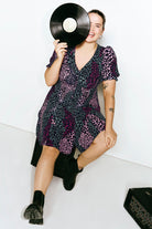 Scamp and Dude Khaki with Pink Spliced Leopard Short Tea Dress | Model wearing a short v neck tea dress in a spliced leopard print with button front placket.