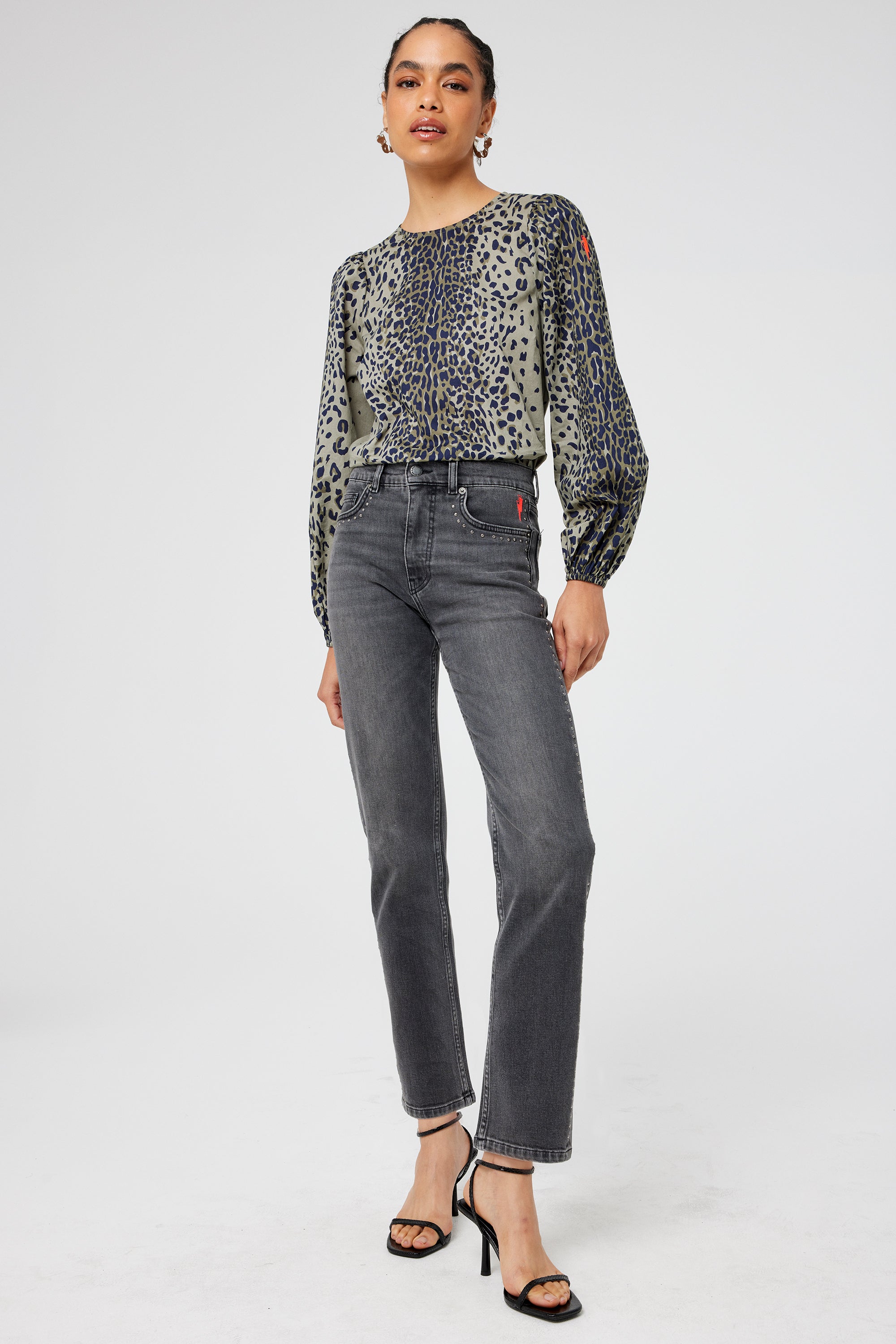 Scamp and Dude Washed Black Studded Straight Leg Jeans | Model wearing washed black jeans with studded detail paired with a khaki leopard print blouse.