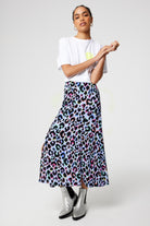 Scamp and Dude Light Blue with Rainbow Shadow Leopard Split Front Skirt | Model wearing a white graphic t shirt with a light blue midi skirt that features rainbow shadow leopard print.